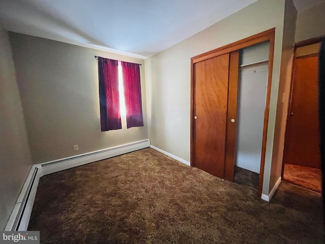 unfurnished bedroom featuring dark carpet and a closet