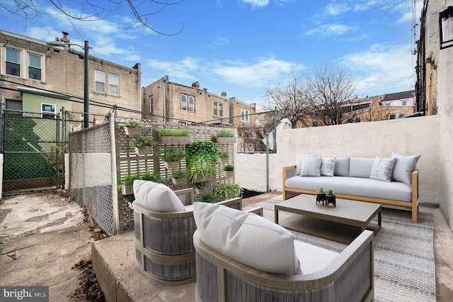 view of patio with an outdoor hangout area, fence, and a residential view