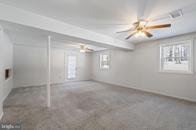 carpeted spare room with ceiling fan