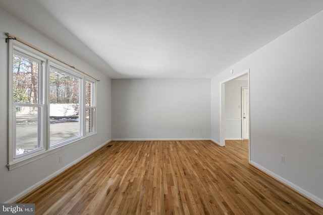 unfurnished room with light wood-type flooring