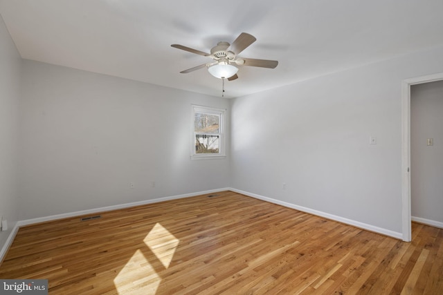 spare room with light hardwood / wood-style flooring and ceiling fan