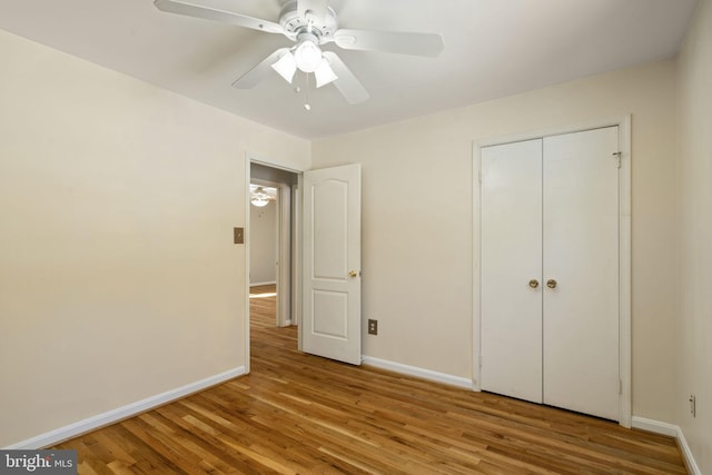 unfurnished bedroom with light hardwood / wood-style floors, a closet, and ceiling fan