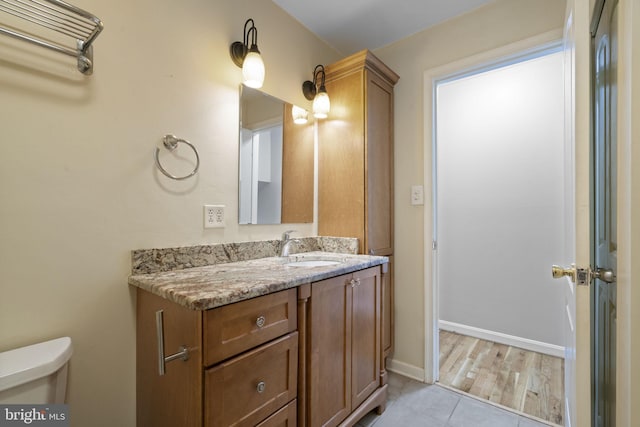 bathroom with vanity, tile patterned floors, and toilet