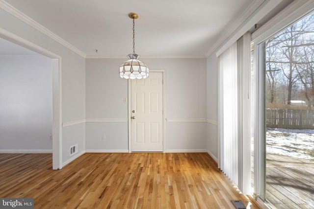 unfurnished dining area with crown molding and light hardwood / wood-style floors