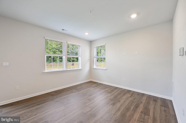 unfurnished room with dark wood-type flooring