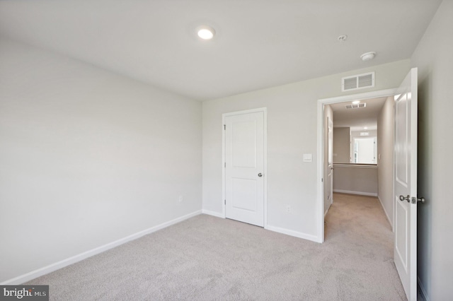 unfurnished bedroom with light colored carpet