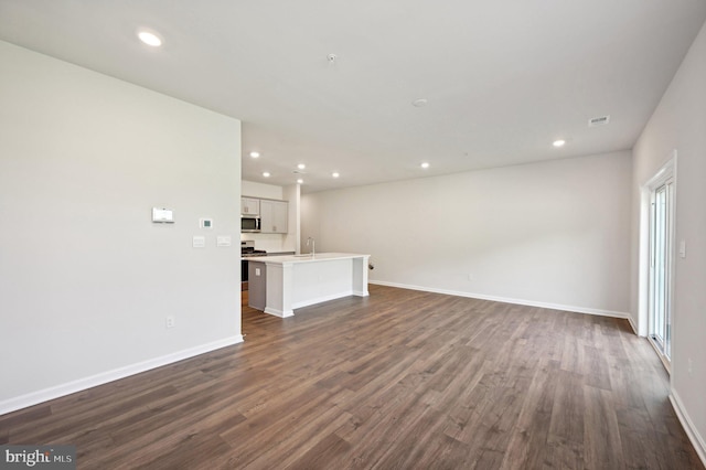 unfurnished living room featuring dark hardwood / wood-style flooring