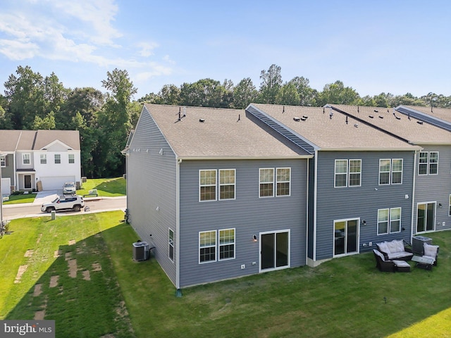 rear view of property with a yard and cooling unit