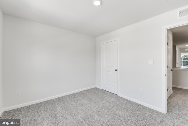 unfurnished bedroom featuring light carpet