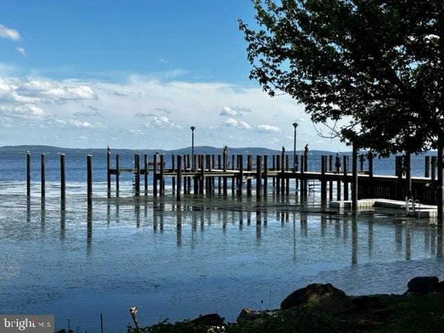 view of dock featuring a water and mountain view