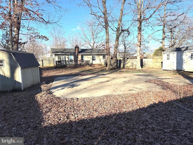 view of yard featuring a patio area and a storage shed