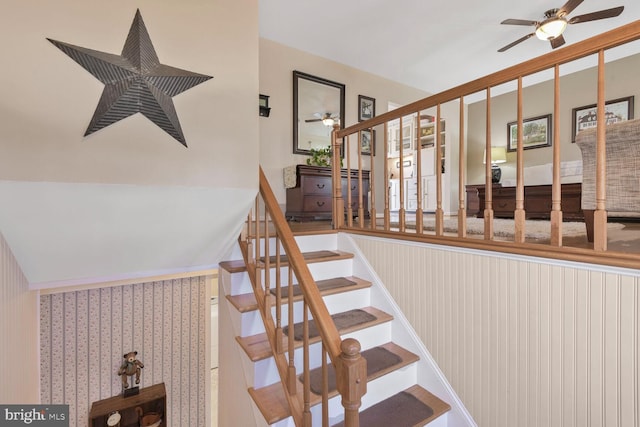 staircase featuring ceiling fan