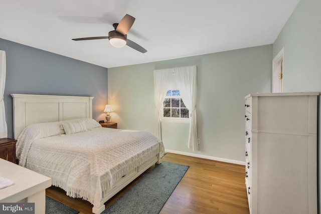 bedroom with hardwood / wood-style flooring and ceiling fan