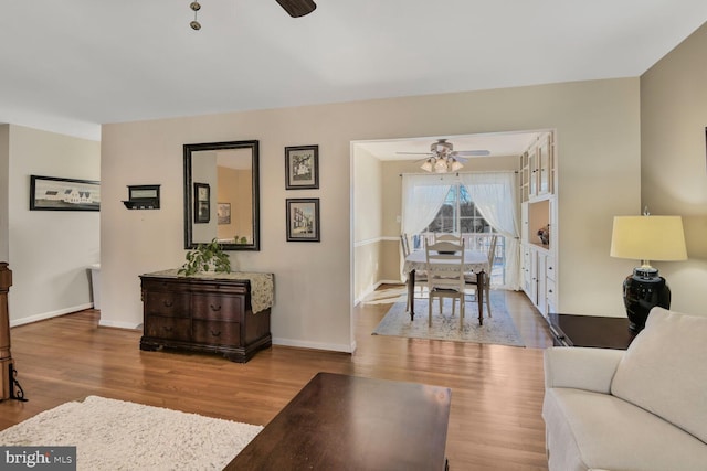 living room with ceiling fan and light wood-type flooring