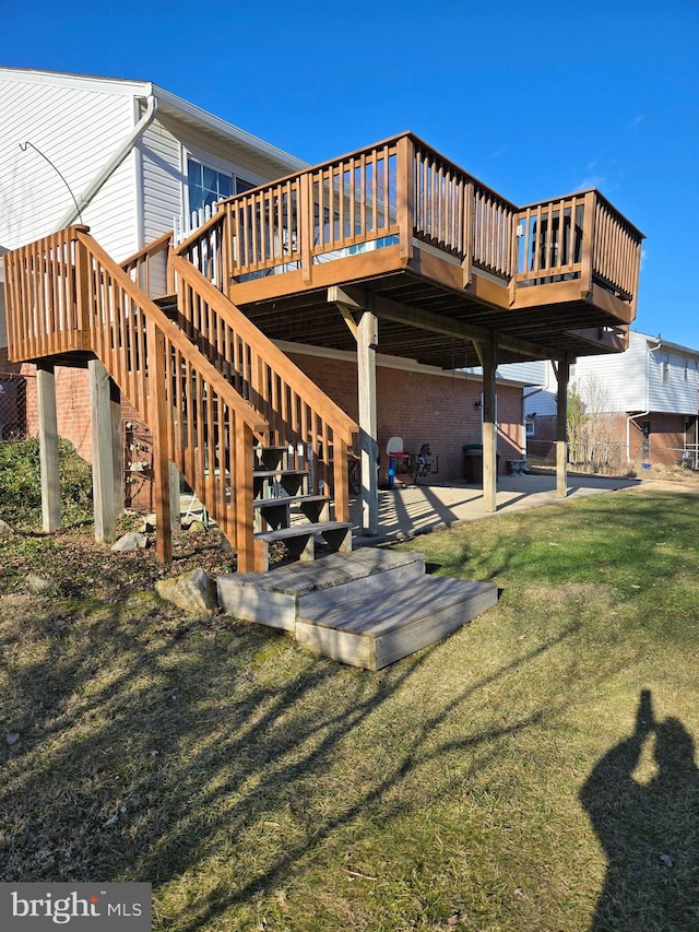 back of property with a lawn, a patio, and a deck