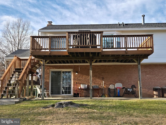 rear view of house with a yard and a deck