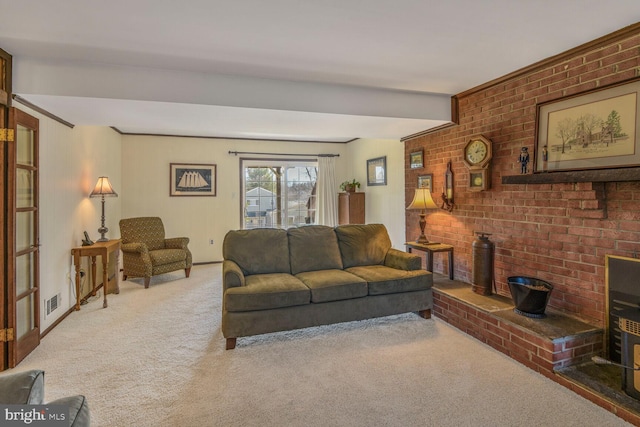 carpeted living room with brick wall and a fireplace