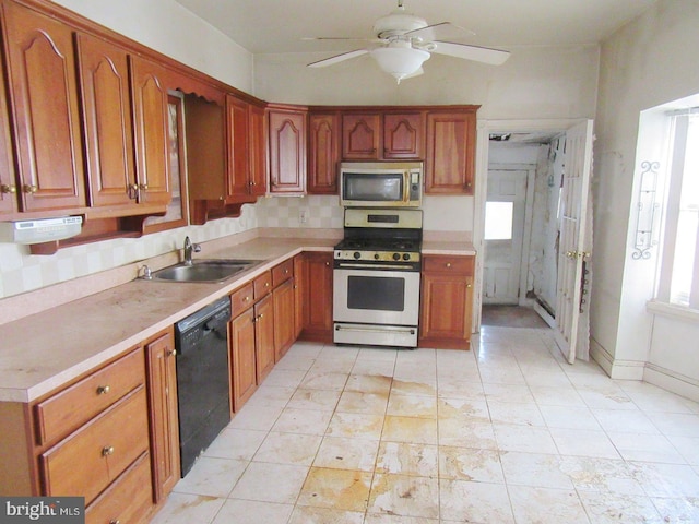 kitchen featuring sink, appliances with stainless steel finishes, tasteful backsplash, and ceiling fan