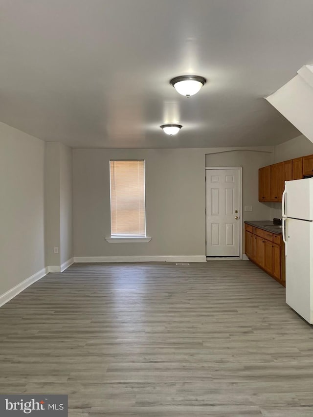 interior space with white refrigerator and light wood-type flooring