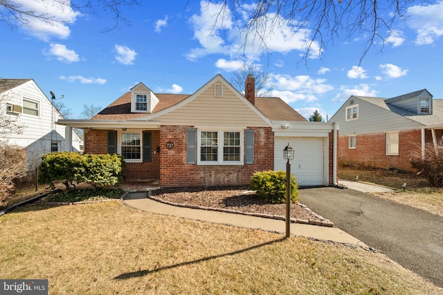 view of front of home with a front yard and a garage