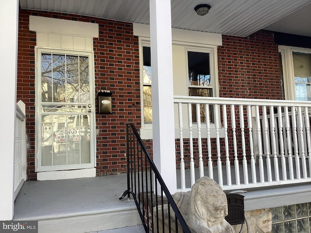 view of exterior entry with a porch