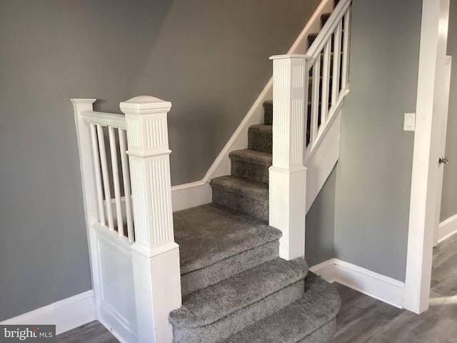stairs with hardwood / wood-style flooring