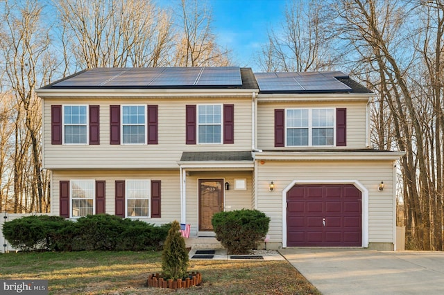 view of front of home with a garage and solar panels