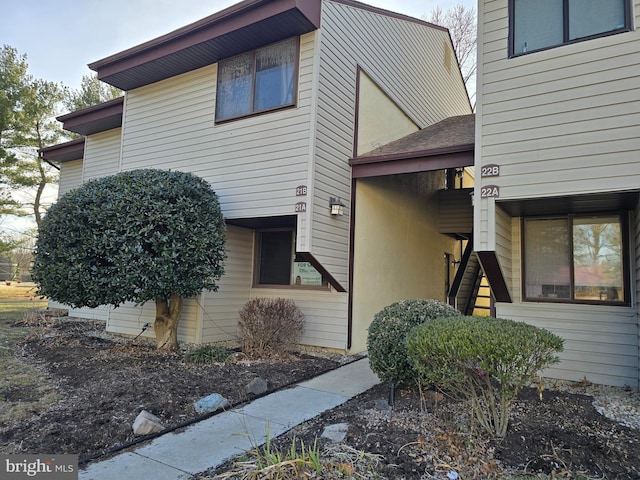 view of side of home featuring stairway