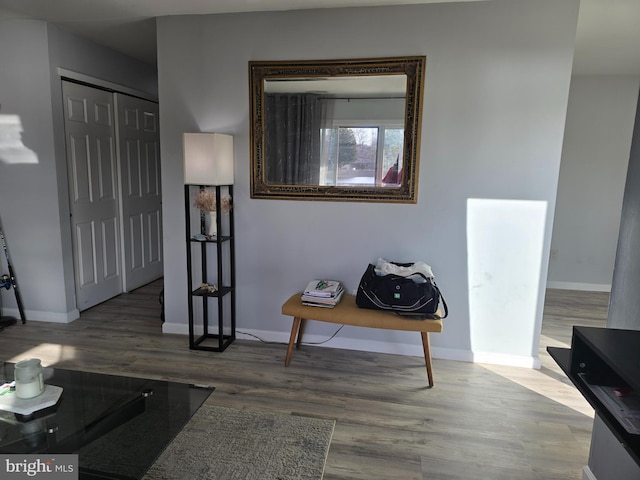 hallway with baseboards and wood finished floors