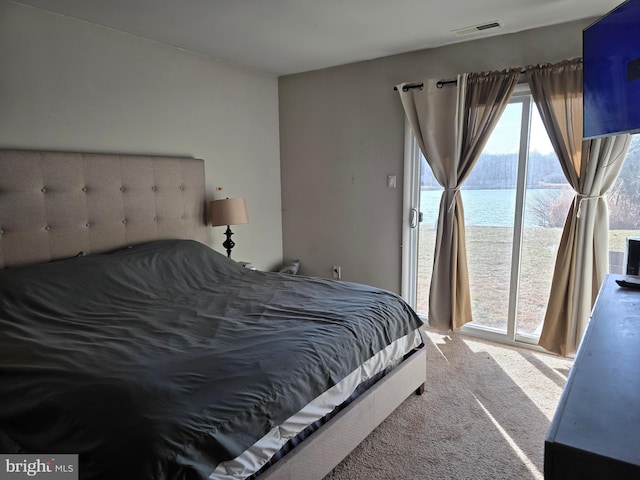 carpeted bedroom with access to exterior and visible vents