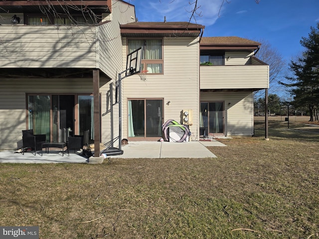 back of house with a patio, a balcony, and a lawn