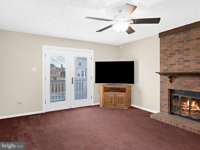 unfurnished living room featuring a textured ceiling, french doors, carpet floors, baseboards, and a brick fireplace