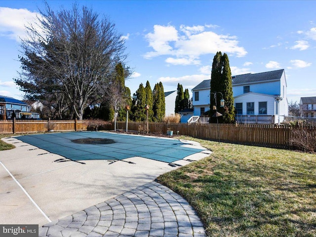 view of pool with a patio area, a fenced in pool, fence private yard, and a yard