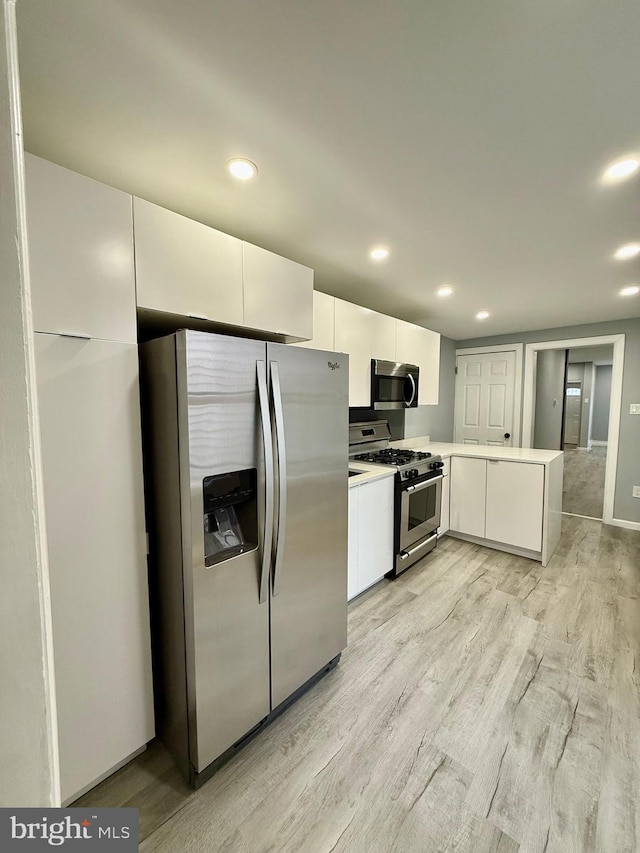 kitchen featuring white cabinetry, appliances with stainless steel finishes, and light wood-type flooring