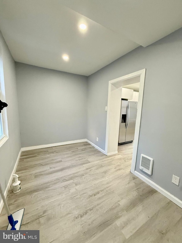 spare room featuring light hardwood / wood-style floors