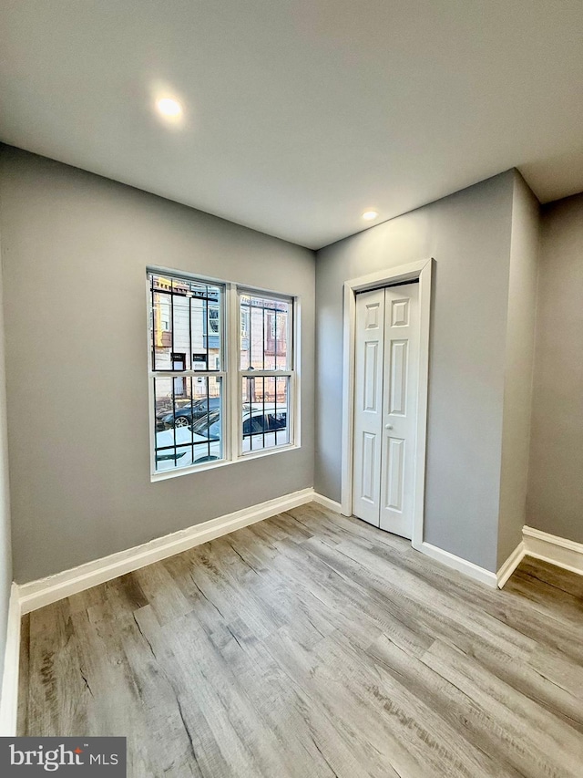 interior space featuring light wood-type flooring and a closet