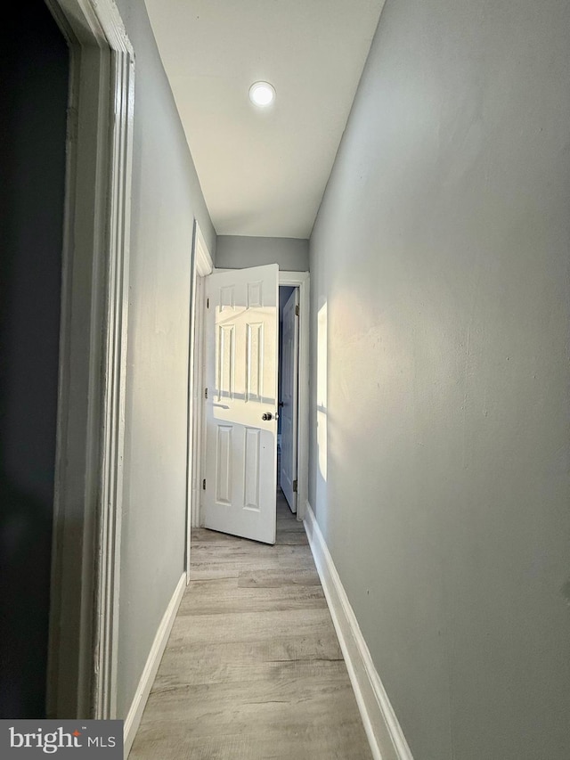 hallway with light hardwood / wood-style flooring