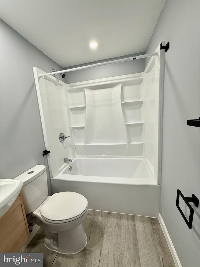 full bathroom with toilet, vanity, shower / bath combination, and wood-type flooring