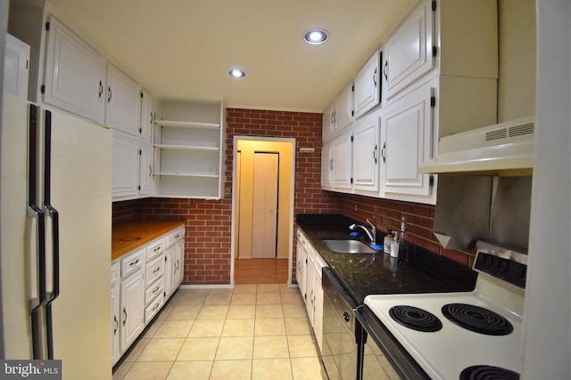 kitchen with sink, white appliances, white cabinetry, and brick wall