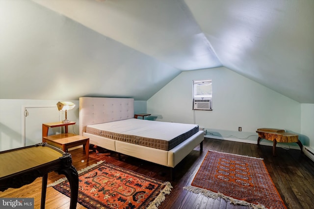 bedroom with cooling unit, lofted ceiling, and dark hardwood / wood-style flooring