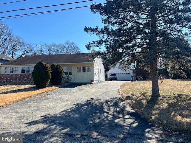 view of front of property with a garage and an outdoor structure