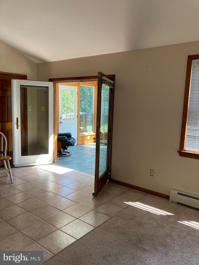 empty room featuring french doors, lofted ceiling, a baseboard radiator, light colored carpet, and light tile patterned flooring