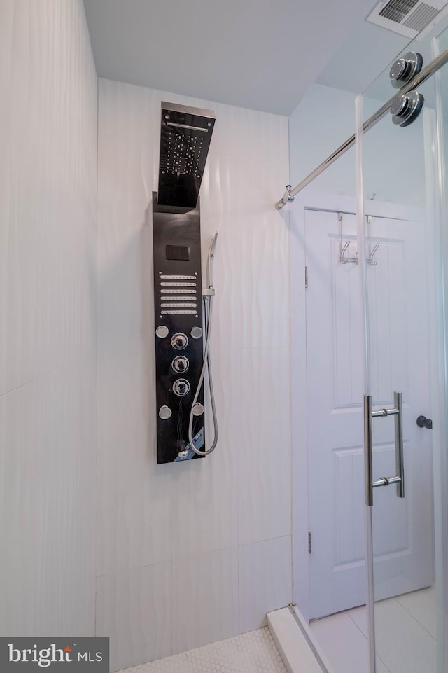 full bathroom with a shower and visible vents