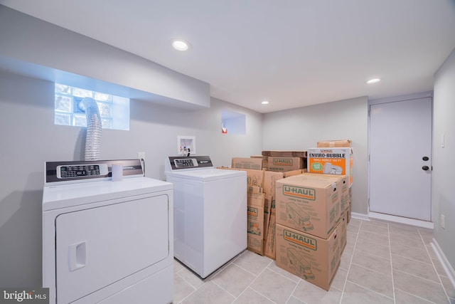 laundry area with recessed lighting, laundry area, light tile patterned flooring, and separate washer and dryer