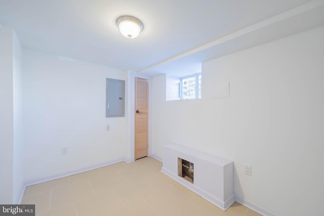 unfurnished room featuring electric panel and baseboards