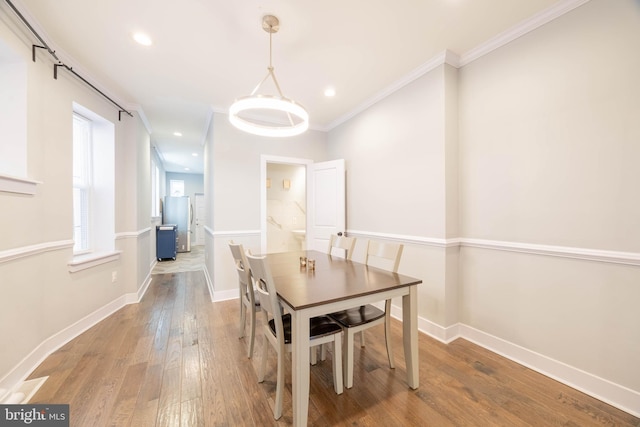 dining space with ornamental molding, recessed lighting, baseboards, and hardwood / wood-style floors