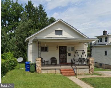 bungalow-style home featuring a porch and a front yard