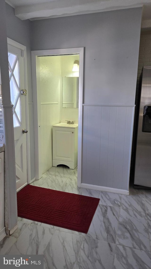 interior space with marble finish floor and wainscoting