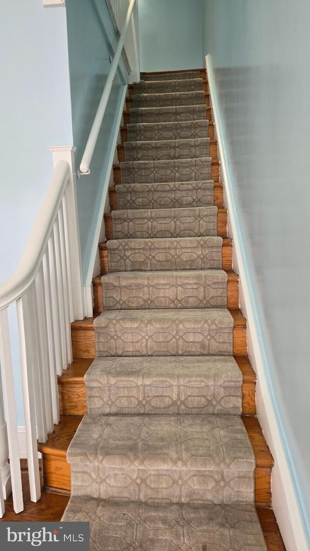 stairway with wood finished floors