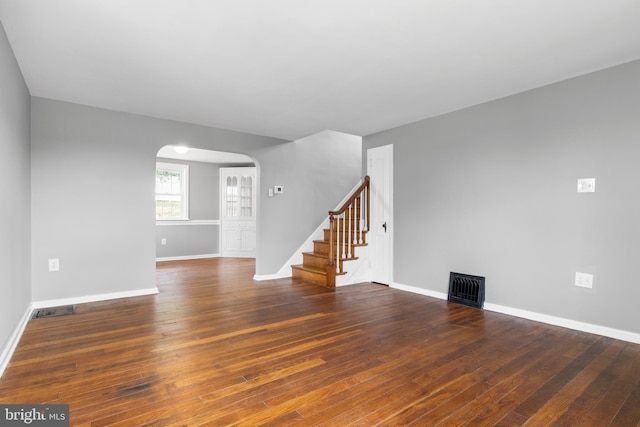 unfurnished room with dark wood-type flooring